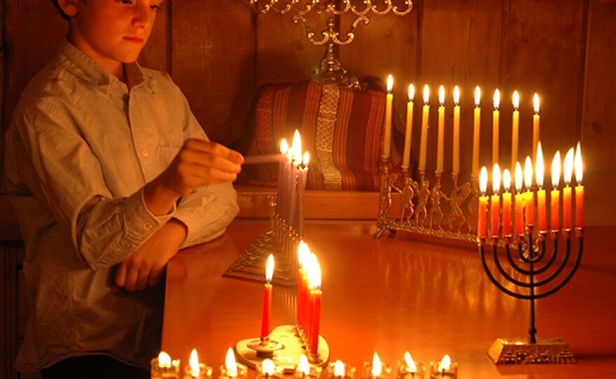 "Hanukkah: A Festival Of Delights" examines the traditions at the center of the Jewish holiday of Hanukkah, including lighting candles (pictured) for eight nights on the lamp known as a menorah.