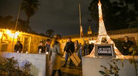 People wait in line at a vigil outside Balboa Park's House of France to record their feelings about the deadly attack in Paris at Charlie Hebdo, a weekly magazine, Jan. 8, 2015.