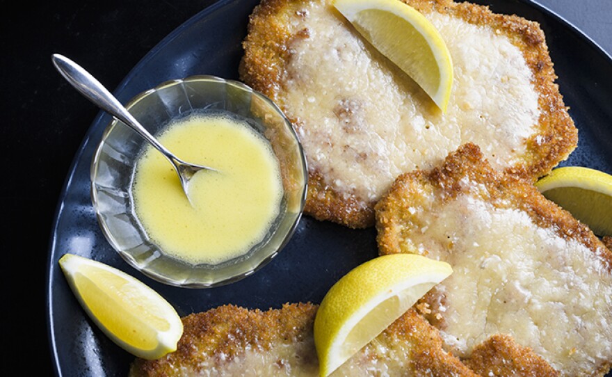 Bolognese-Style Pork Cutlets, covered in prosciutto, topped with parmesan and served with a bright lemon butter sauce.