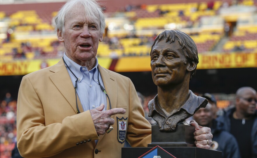 File photo of former Washington Redskins general manager Bobby Beathard posing with his Hall of Fame trophy during halftime of an NFL football game between the Houston Texans and the Washington Redskins, Nov. 18, 2018, in Landover, Maryland.
