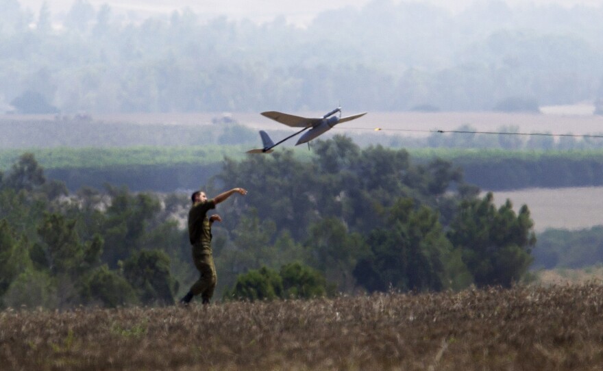 An Israeli soldier launches a  drone that's attached to a military vehicle in southern Israel, not far from the border with the Gaza Strip, on July 29. Israel was a pioneer with drones and has developed a number of military technologies that it later sells abroad.