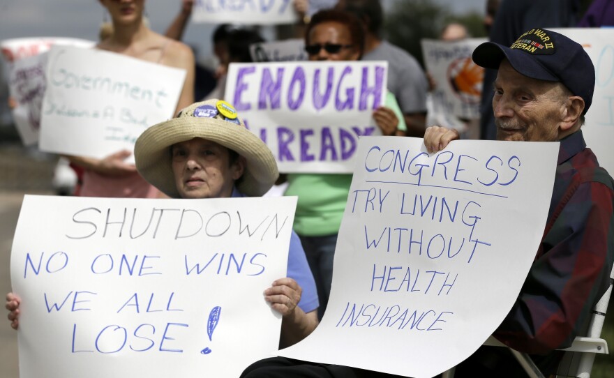 Susan and Jack Cooper of Richardson, Texas, demonstrate against the government shutdown in Dallas this month.