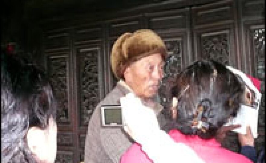 Abu Wangdui, 77, is besieged by visitors inside his 400-year-old house. He complains that neither he nor his house can withstand the pressure of so many visitors.