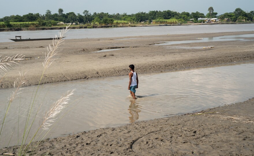 A young man living on a small river island known as a char heads out to catch a boat and cross the Brahmaputra River to the mainland, in Assam's Barpeta district. To live in Assam legally, people must be registered by the government. But some 4 million people have been excluded from the National Register of Citizens, a sort of statewide census.