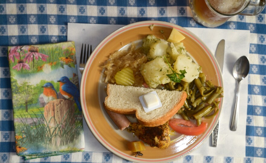 The sampler plate at the Hütte Restaurant included parsley potatoes, sauerkraut, bratwurst, green beans, curried chicken, bread and a chunk of Swiss cheese.
