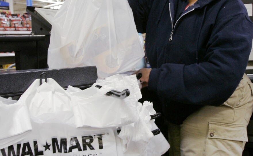 Cashier Shawntee Powell bags merchandise at Chicago's Walmart in 2007. Other big-box stores, including Target, also have big-city plans.