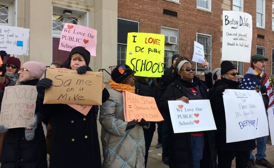 Protesters gather outside Jefferson Middle School in Washington, where Education Secretary Betsy DeVos paid her first visit as education secretary.
