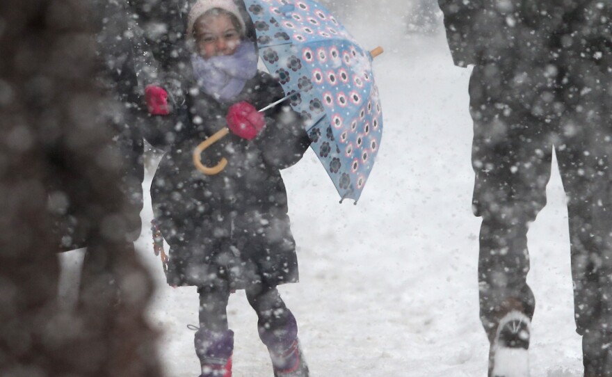 A little girl on her way to school Thursday in New York City. Mayor Bill de Blasio and his aides have come under fire for not closing the city's schools before a winter storm hit.