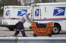 A U.S. Postal Service employee pushes a cart outside a post office in Wheeling, Ill., in 2021.