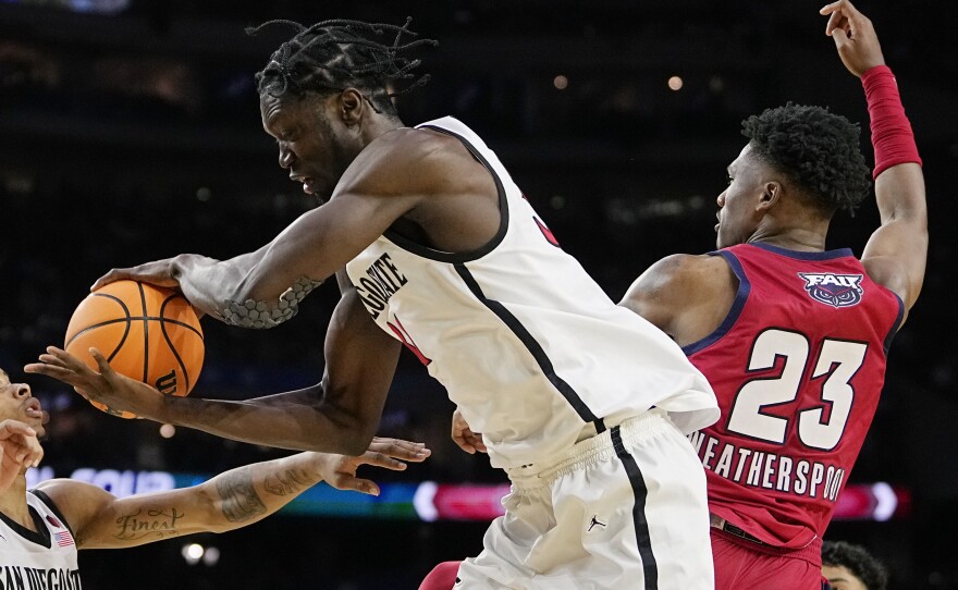 San Diego State forward Nathan Mensah, left, vies for the ball with Florida Atlantic guard Brandon Weatherspoon during the first half of a Final Four college basketball game in the NCAA Tournament on Saturday, April 1, 2023, in Houston.