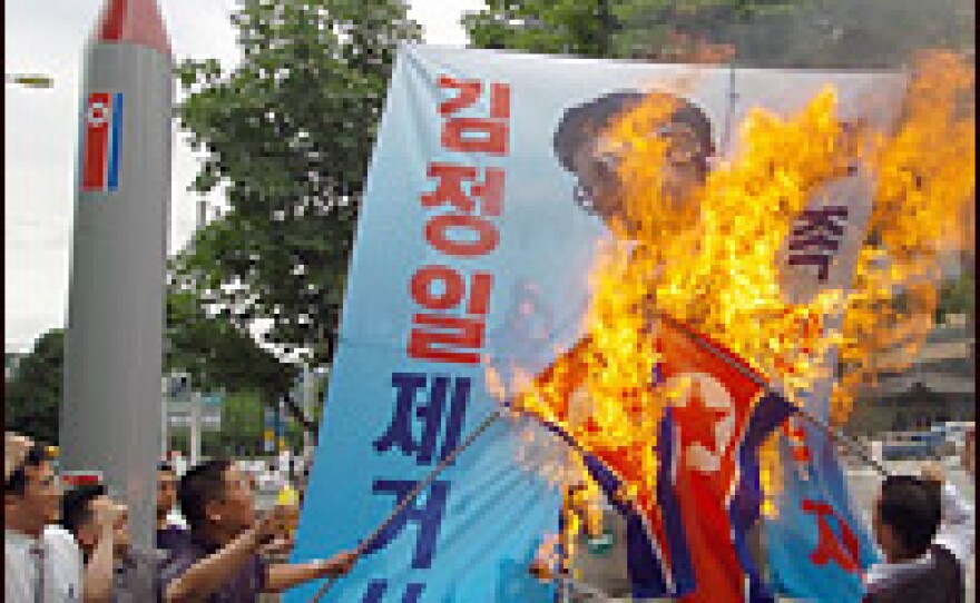 South Korean demonstrators burn North Korean flags, and a portrait of North Korean leader Kim Jong-Il, during a protest on Wednesday denouncing North Korean missile testing.