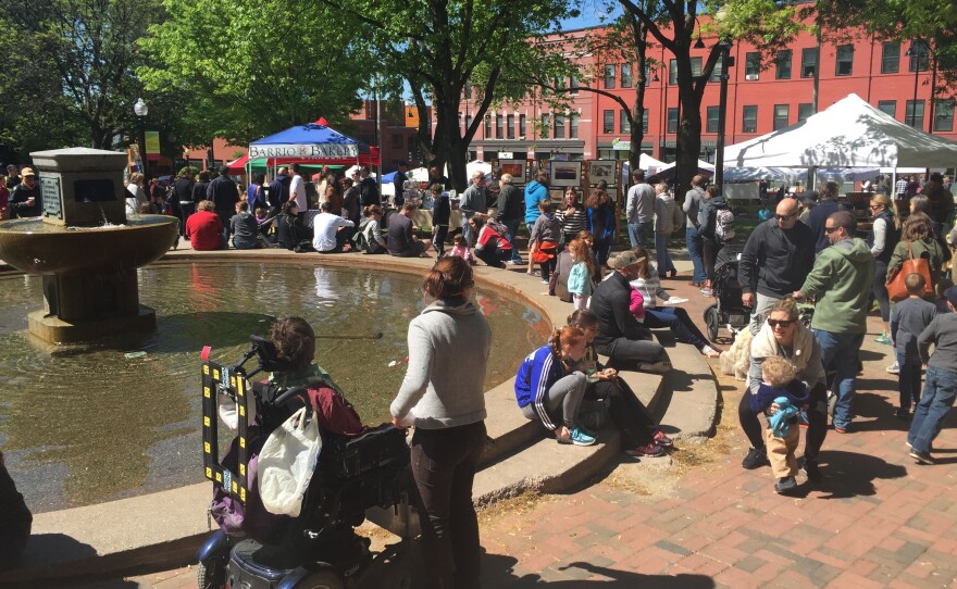 Vermonters crowd a farmers market in downtown Burlington, Vt.