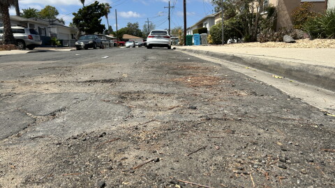 A close up view of a road in the College East neighborhood of San Diego that has been identified in the city's Pavement Management Plan as in need of repair.