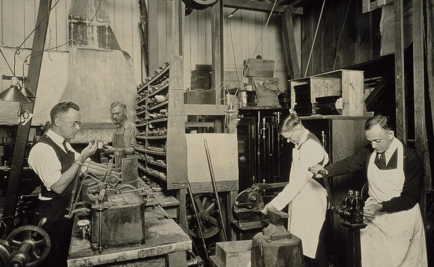 Men are shown working in the back shop at Jessop's Jewelers in this historic photo.