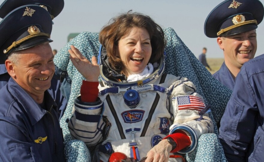 Russian space agency rescue team members carry U.S. astronaut Cady Coleman after her space capsule landed in Kazakhstan in May 2011.