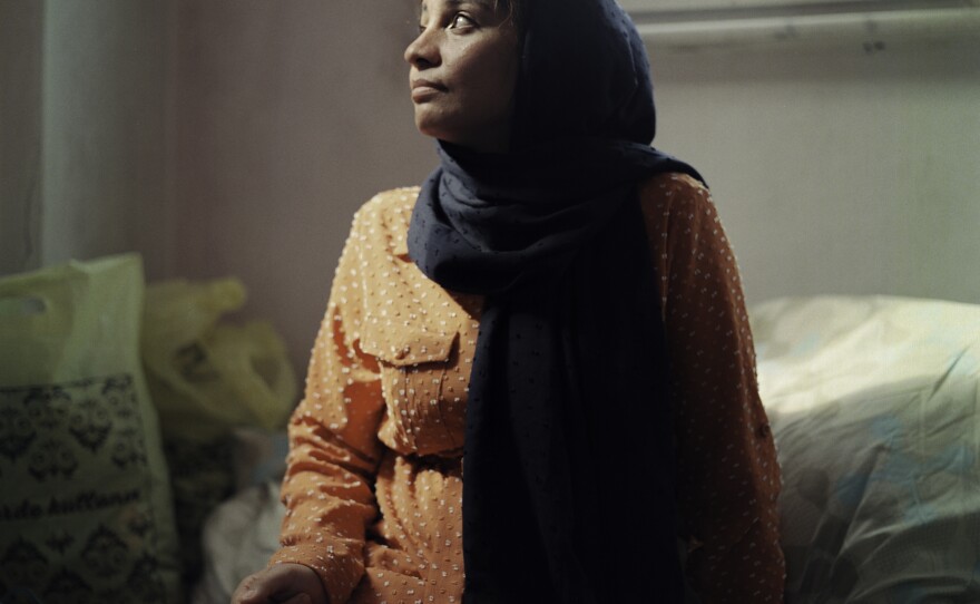 Mahbube Hussaini, 25, was born in Iran to Afghan refugee parents. Because her family was not formally registered to live in Iran, she was unable to attend school there. These days, 9-year-old Elisa helps her practice her handwriting in a spare notebook.