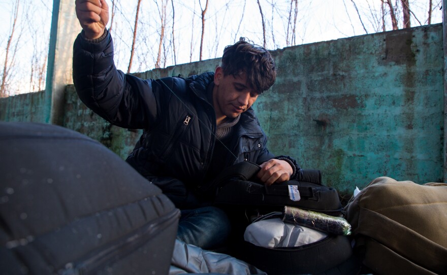 Afghan Morteza Mohammadi, 21, sews his backpack in the ruins of the former Krajina Metal factory. He prepares for an attempt to cross into European Union members Croatia, Slovenia and Italy. Migrants and refugees here refer to the trip as "the game."