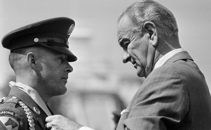President Lyndon Johnson awards the Medal of Honor to Army Staff Sgt. Delbert O. Jennings of Stockton, Calif., for heroism in Vietnam on the White House grounds on Sept. 19, 1968.