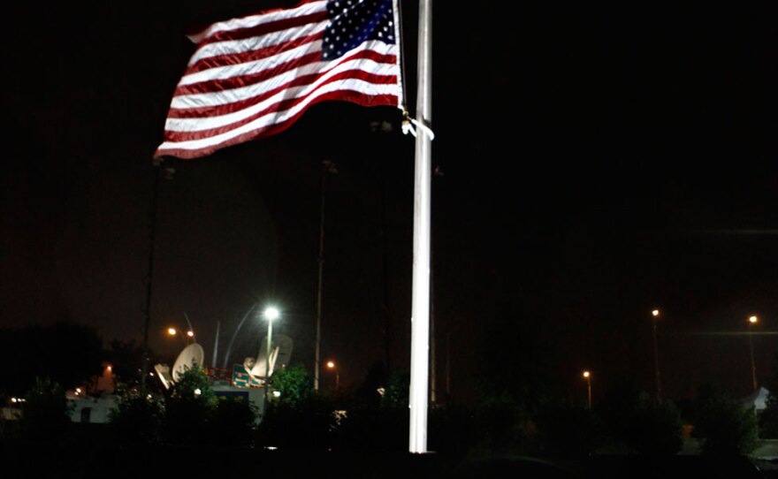 A rain-soaked American flag flies at half-staff Friday at the Pentagon memorial honoring the 184 people who were killed there in the 2001 attack.