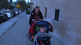 Christy Riddle pushes her 9-month-old baby, Charlie, in his stroller from the Rescue Mission Emergency Shelter.
