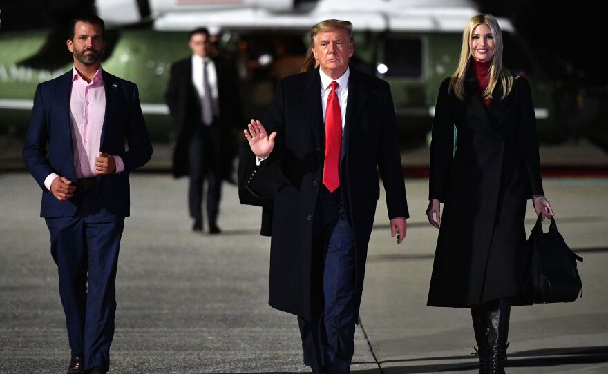Former President Donald Trump and his daughter Ivanka Trump and son Donald Trump Jr. make their way to board Air Force One before departing  Marietta, Georgia on January 4, 2021, as the family rallied supporters after Trump's election loss.