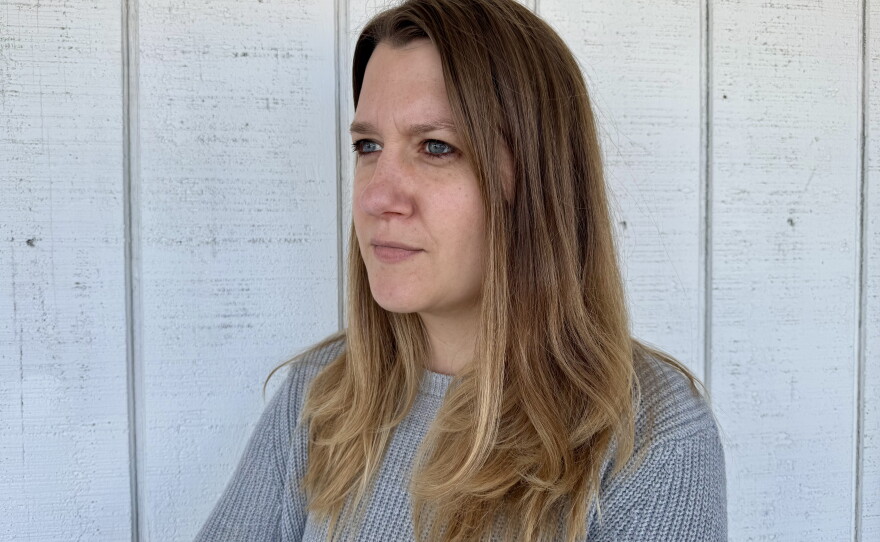 Carrie Goldstein stands outside her home on October 4, 2026. Home prices and mortgage rates prevent her from moving.