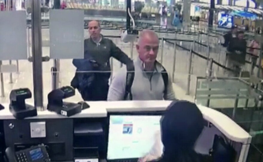 This Dec. 30, 2019 image from security camera video shows Michael L. Taylor, center, and George-Antoine Zayek at passport control at Istanbul Airport in Turkey. Taylor and his son Peter, are charged in Japan with helping Nissan's former chairman, Carlos Ghosn, jump bail and escape Japan for Lebanon.