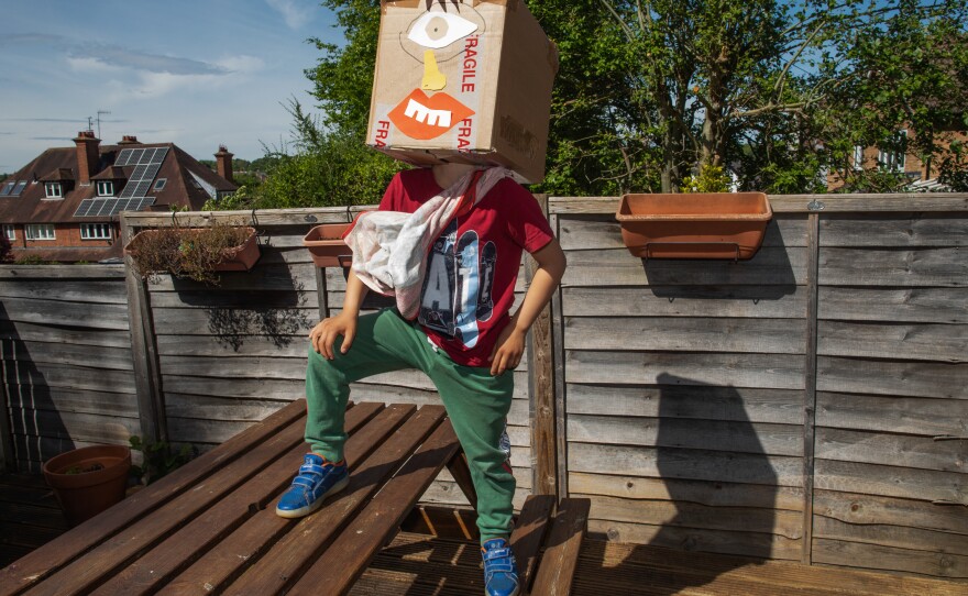 Joe tests out a pinhole camera he crafted for one of his homeschooling assignments.