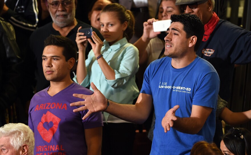 Angel Fernandez, left, and Jose Patino interrupt U.S. President Barack Obama's speech on U.S. immigration policy Friday at Del Sol High School on in Las Vegas. The two, who were brought to the United States as children and are protected from deportation by the president's policies, were upset that their parents still could be forced to leave.