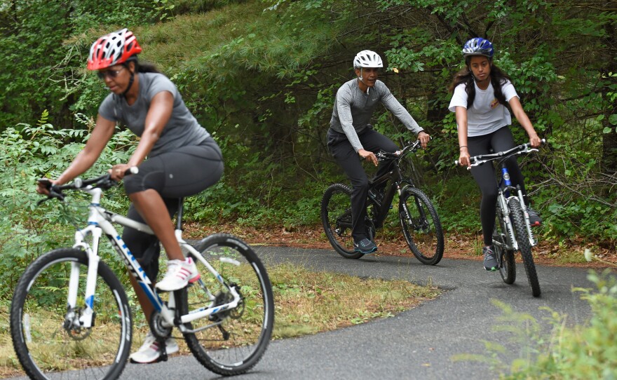 President Barack Obama rides bikes with his wife, Michelle, and daughter, Malia, on Martha's Vineyard in August 2015.