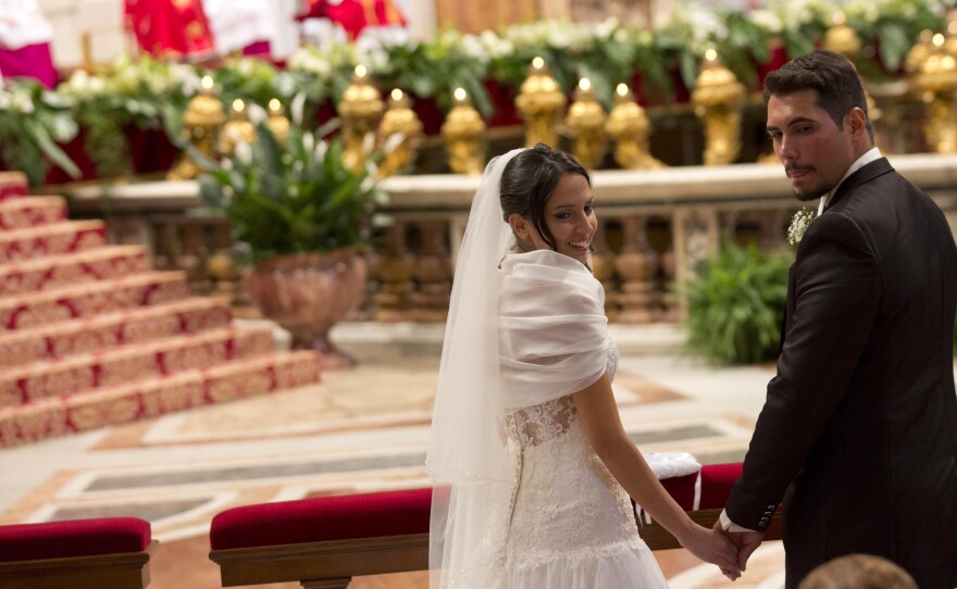 Sara Pisano (left) and Danilo Spagnoli, just married by Pope Francis, smile during the wedding ceremony in St. Peter's Basilica at the Vatican, Sept. 14. Pope Francis married 20 couples on Sunday, including some who already live together or who already have children, both technically sins in the eyes of the church.