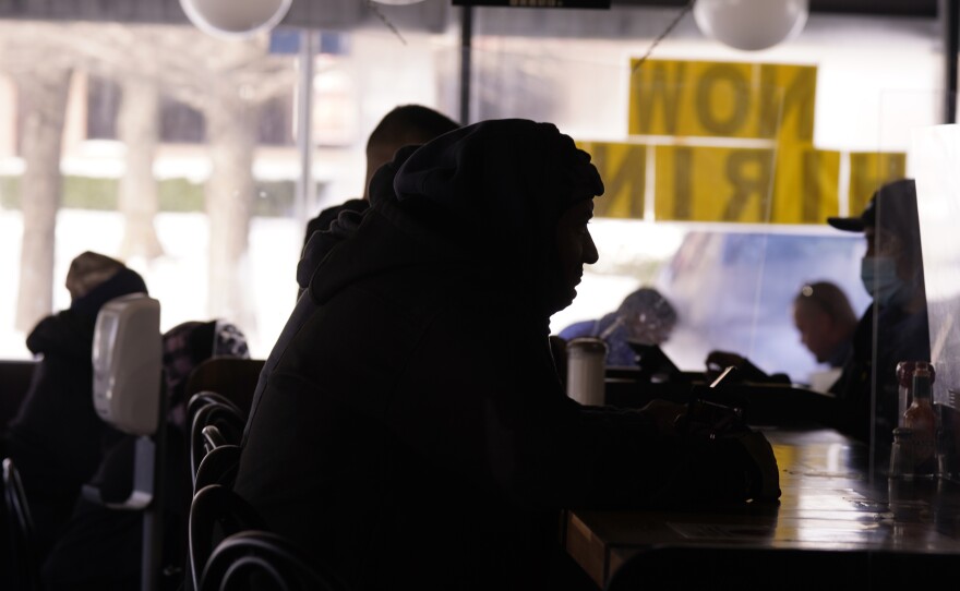 Patrons sit in a restaurant without power caused by cold weather blackouts on Tuesday in Richardson, Texas.