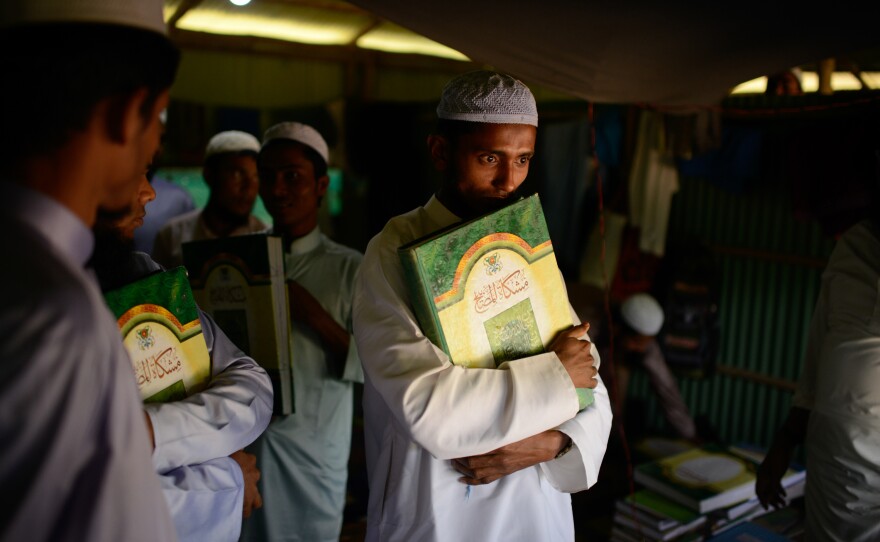 A student holds an Islamic text at a madrassa in the Kutupalong Rohingya refugee camp. With limited educational opportunities for children in the camps, many Rohingya families are sending their kids to madrassas to study Arabic and Islamic studies.