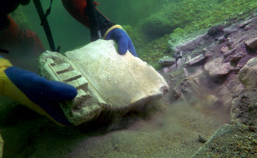 Diver moving a stone element from an underwater temple off the coast of Alexandria.