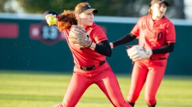 San Diego State Aztecs shortstop Shelby Johnston throws the ball as teammate infielder Jillian Celis looks on during the game against BYU on Feb. 15, 2020.