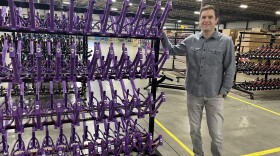 Brian Riley, the CEO of the Guardian Bike Company, showcases a rack of frames that were built in his factory in Seymour, Indiana.