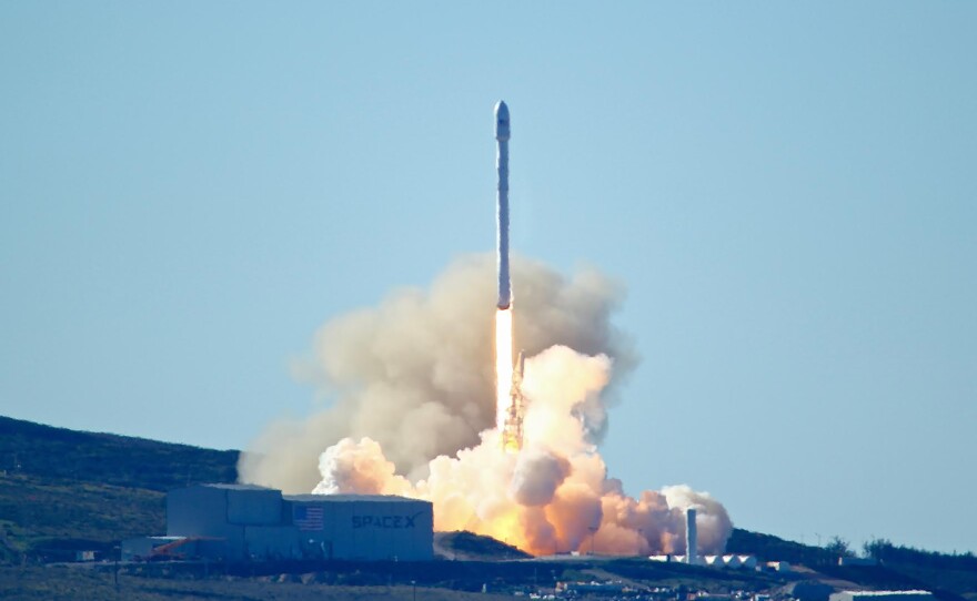 Space-X's Falcon 9 rocket with 10 satellites launches at Vandenberg Air Force Base, Calif., in 2017. The company says it will lay off 10 percent of its workforce.