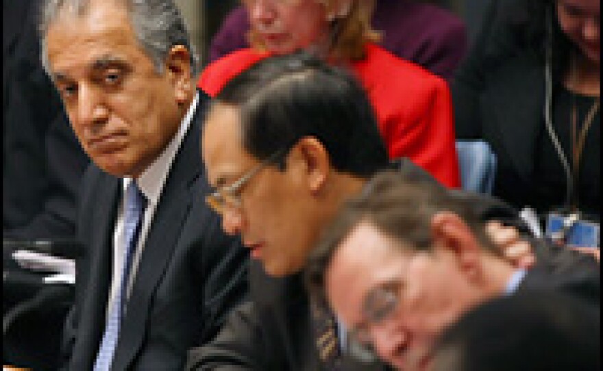 Ambassador to the United Nations Zalmay Khalilzad (left) listens during a United Nations Security Council meeting at U.N. headquarters Wednesday.