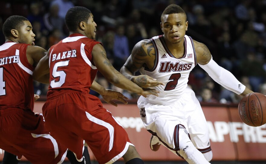 Massachusetts' Derrick Gordon (No. 2) drives past Northern Illinois' Dontel Highsmith (No. 4) and Travon Baker (No. 5) during an NCAA basketball game in Amherst, Mass., on Dec. 14.