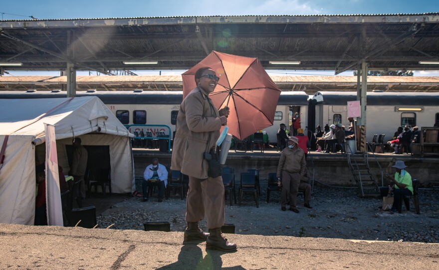 Corrections officer Sesi Motsoaleli watches over a group of prisoners who have been brought to the Phelophepa health-care train during a stop in Kroonstad, South Africa, for various medical procedures and checks. The prison sends its inmates here whenever the train is in town.