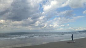 A surfer looks at the waves in Ocean Beach, Nov. 27, 2015.