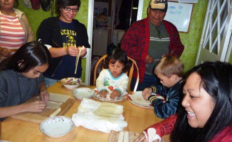 Melanie Vanderlipe Ramil is teaching the young people in her family how to make the traditional dish,lumpia. Here, the family in 2009.