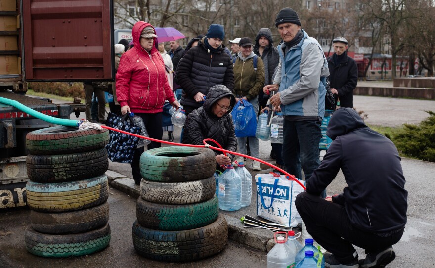 <strong>April 20:</strong> Residents of Mykolaiv, Ukraine, receive bottled water from a truck since there's been no running water for over a week.