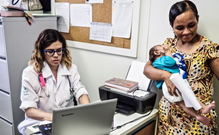 Dr. Danielle Cruz attends to 4-month-old Davi Lucas Francisca da Paz, held by his mother, Eliane Francisca, in an examination room at the Institute of Integral Medicine Hospital in Recife, Brazil.