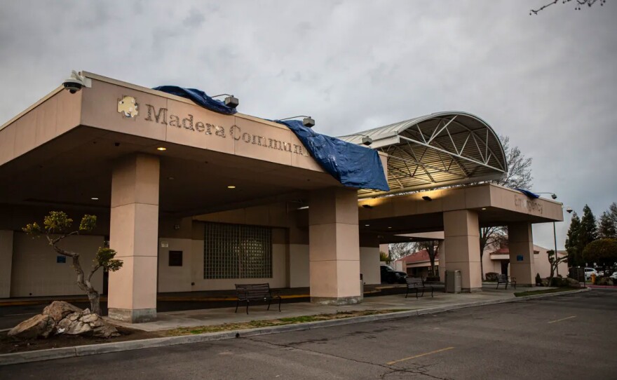 Outlines of the Madera Community Hospital sign being covered by a tarp at the Emergency Room entrance of the hospital on Jan. 2, 2023. Madera County Sheriff Tyson Pogue announced a state of emergency for the county when the hospital shut its doors due to bankruptcy.