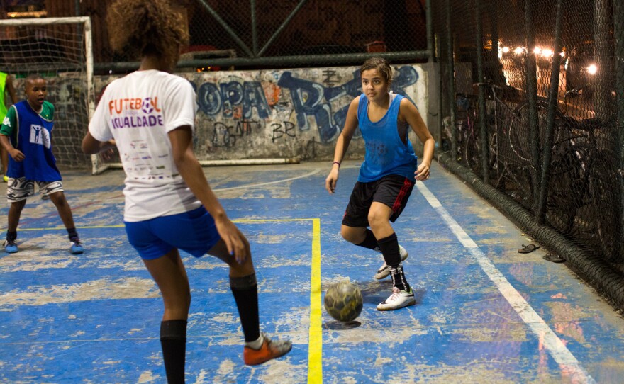 Lala, right, gets ready to make a pass during a practice in Rocinha.