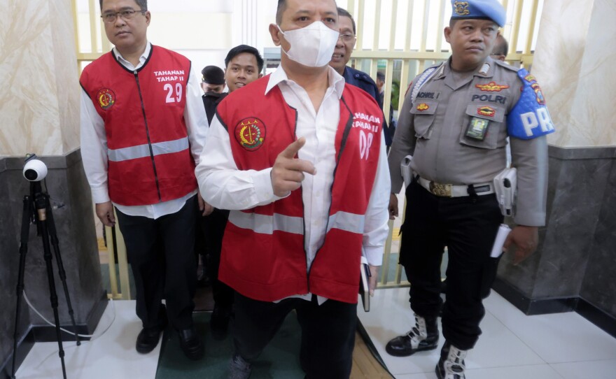 Arema FC Organizing Committee chair Abdul Haris, left, the club's security chief Suko Sutrisno, center, walk to the courtroom to attend their sentencing hearing at a district court in Surabaya, East Java, Indonesia, Thursday, March 9, 2023.