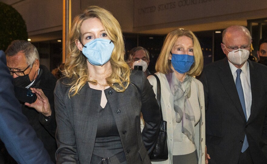 Elizabeth Holmes, center, leaves federal court on Jan. 3 after her verdict in San Jose, Calif. A judge on Wednesday set her sentencing date for Sept. 26 following her conviction on fraud charges.