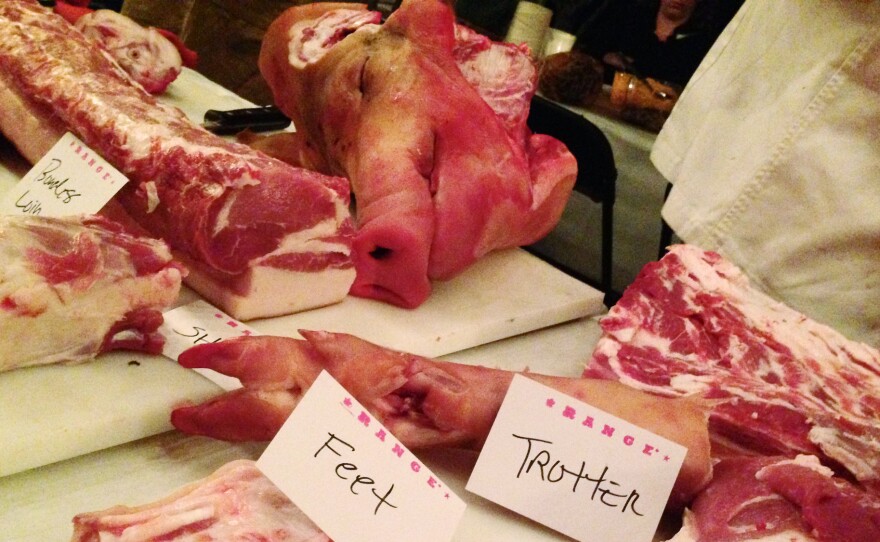 Hog parts are displayed on a table during a workshop for female butchers in Chapel Hill, NC.