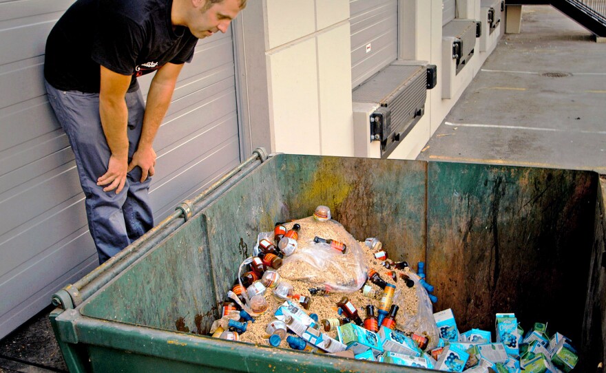 A scene from Just Eat It: A Food Waste Story. Filmmaker Grant Baldwin checks out a dumpster of excess, but edible, food.